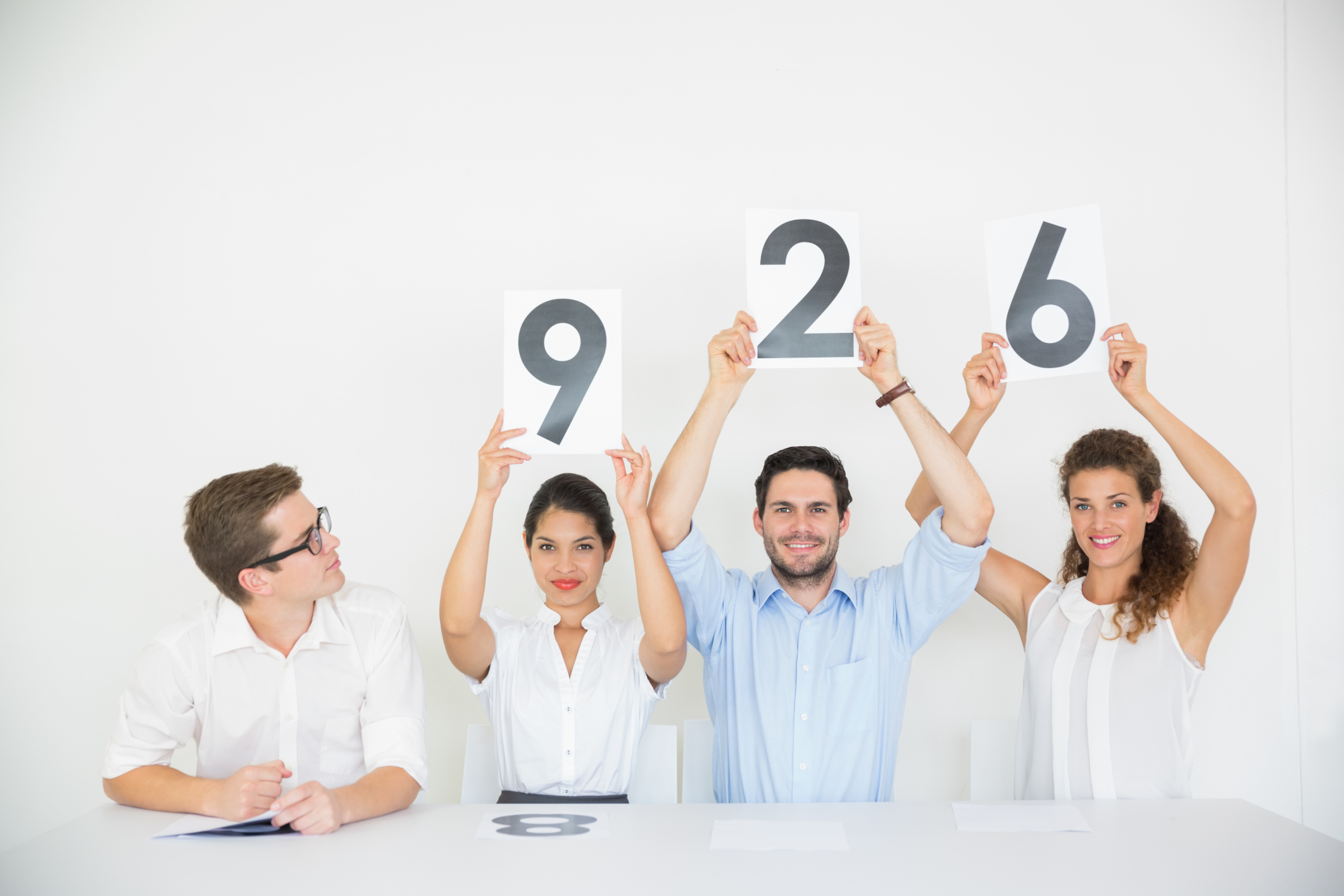 Business people holding score signs