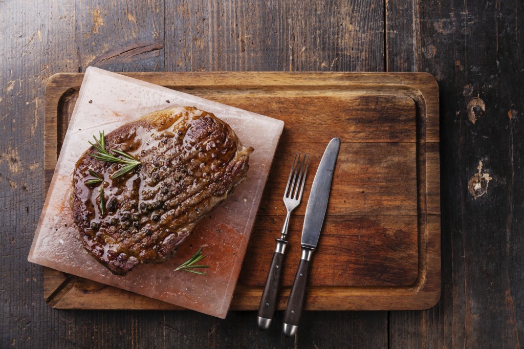 how to have twins, Grilled Black Angus Steak Ribeye on Himalayan pink salt block on dark wooden background