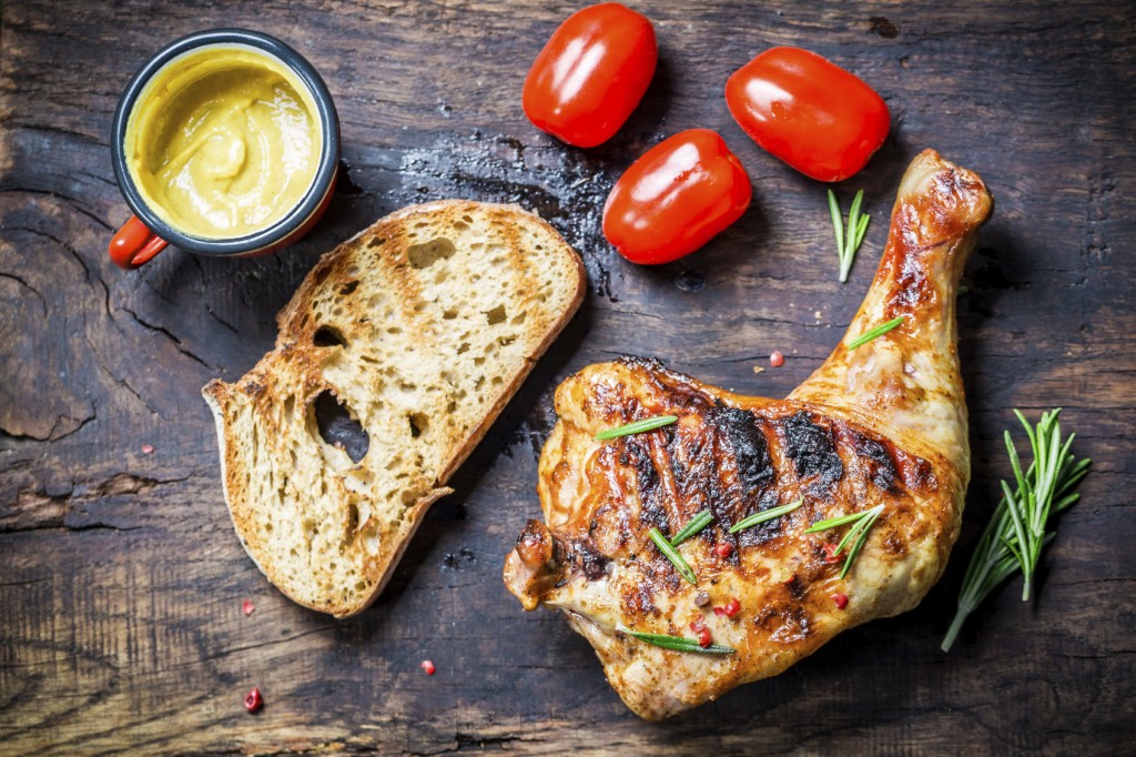 Grilled chicken leg with toast and cherry tomato