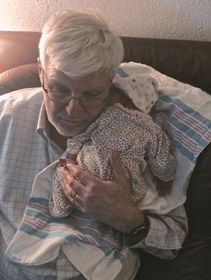 Interim Care Provider, Lewis, relaxing with baby. Facebook