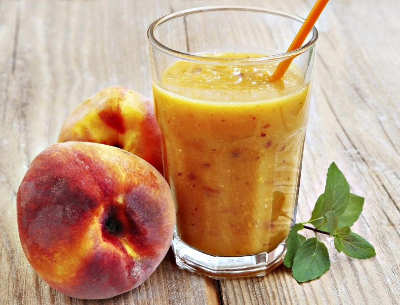 Healthy Delicious Peaches Smoothie in a Glass with Mint Leaves